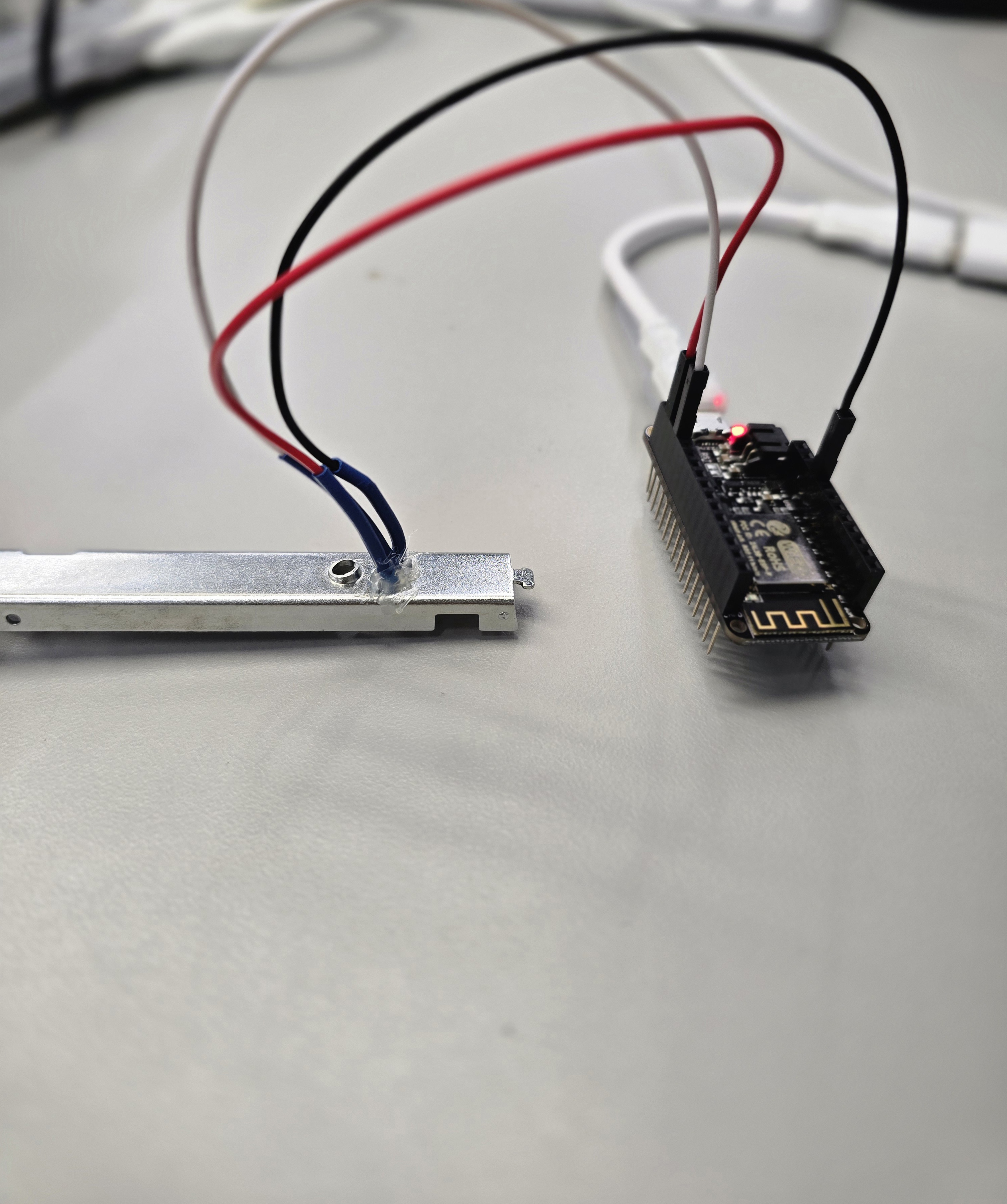 Lead bundle exiting stapler rail toward ESP8266